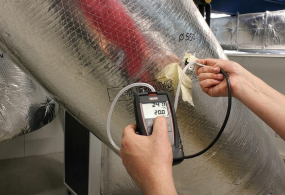 Technician calibrating control loops and analyzing parameters on energy dashboard